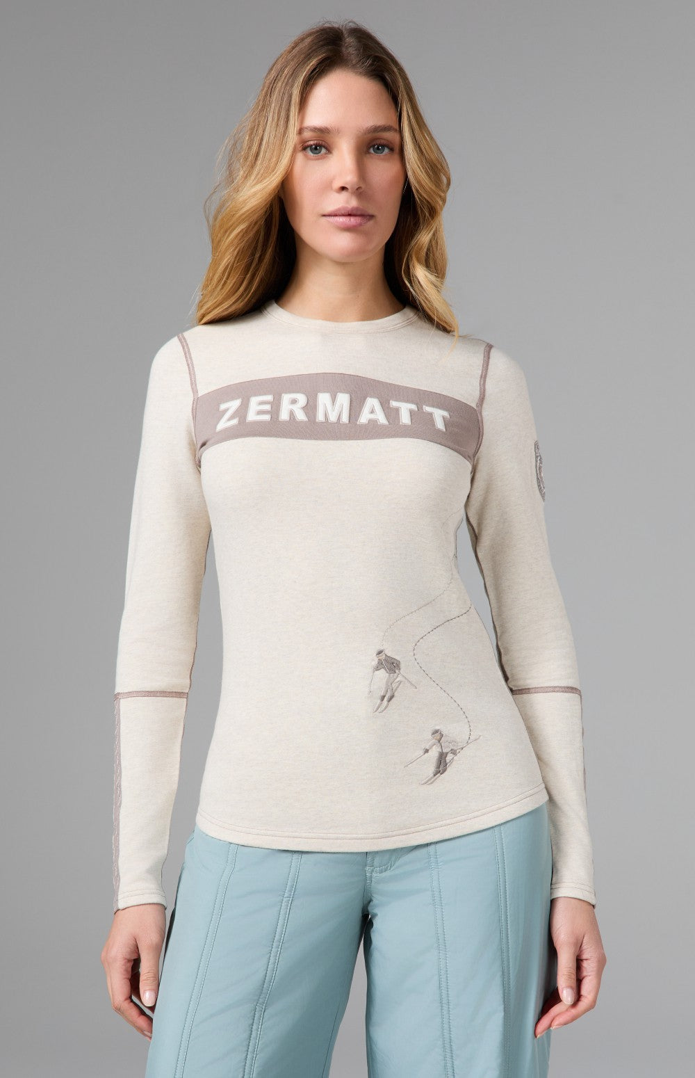 Alp N Rock Zermatt Ski Crew, women's white and taupe longsleeve ski crew with embroidered skiers and Zermatt lettering on chest