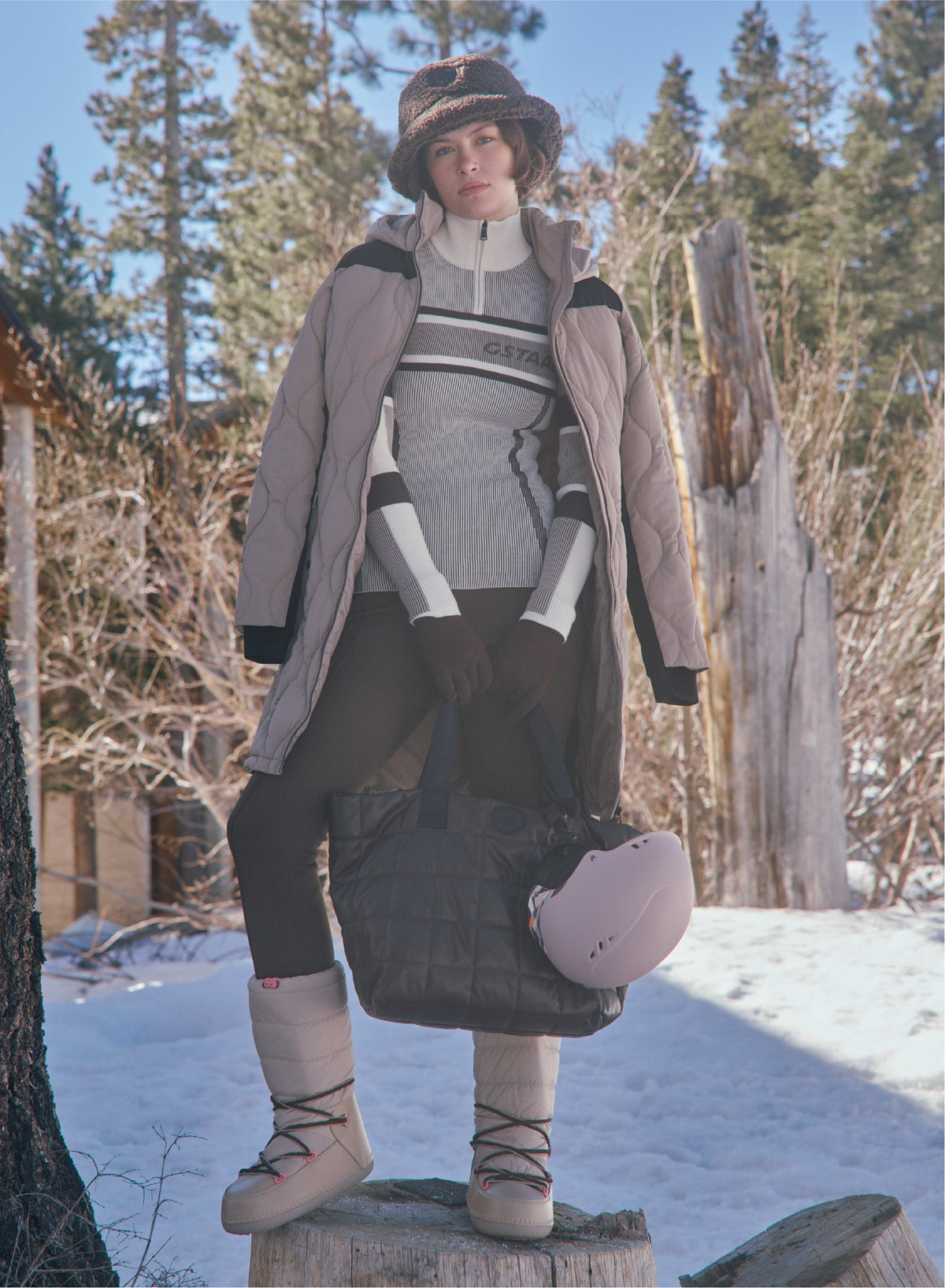 Alp N Rock long taupe quilted puffer coat over a gray and white striped sweater and black fitted pants