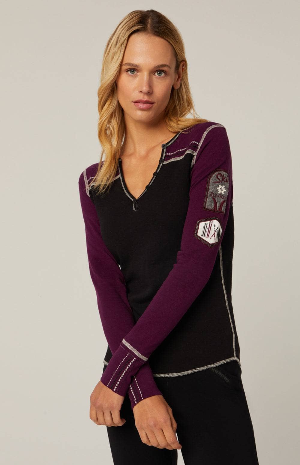 Rassa Henley Shirt by Alp N Rock, Women's Black Henley Shirt With Purple Sleeves and Ski Patches On The Arm